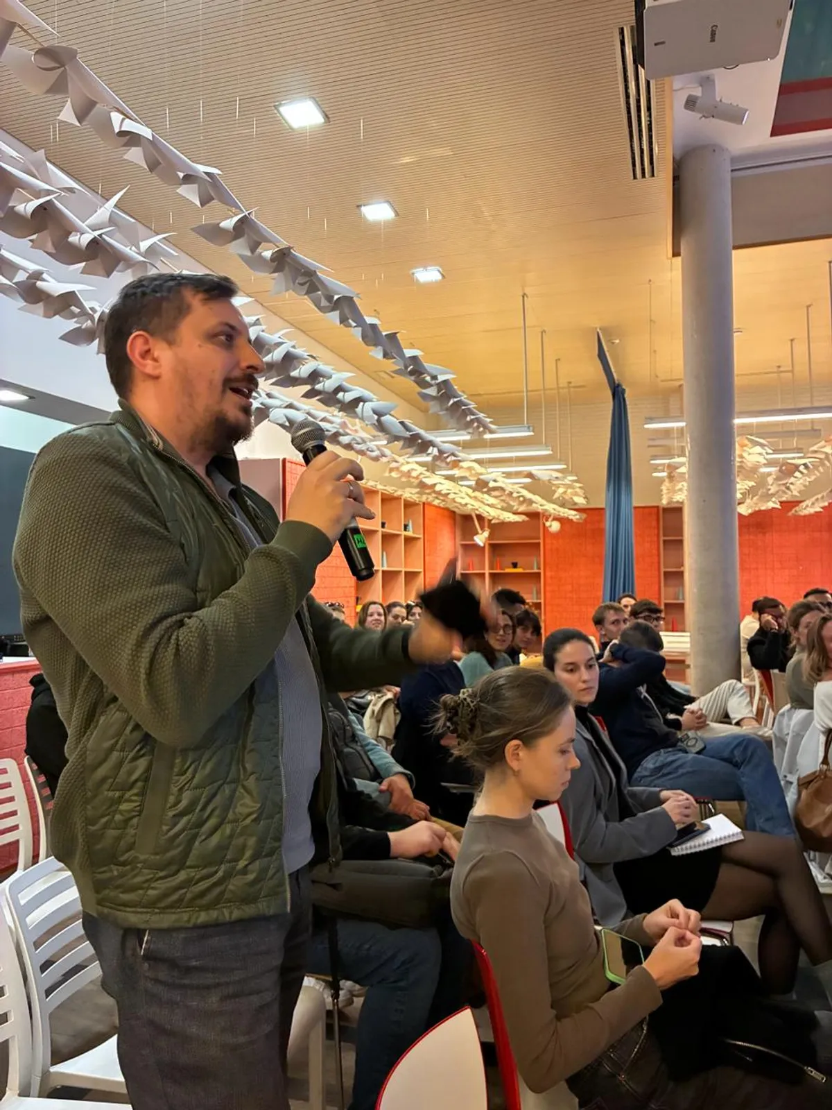 Attendee participating from the audience with a microphone